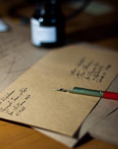 photo of an envelope being hand written