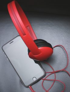 Space Gray Iphone 6 and Red On-ear Headphones