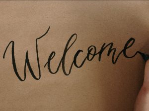 A large "welcome" written by hand