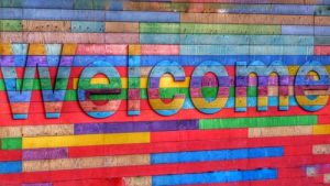 Rainbow coloured block with the word "Welcome" embossed