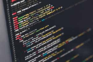 Close up of a laptop screen with code on a dark background