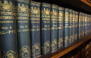 A shelf full of various volumes of encyclopedia britannica to depict a wealth of knowledge