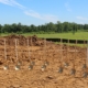 A ploughed field with rows of shovels about to break ground