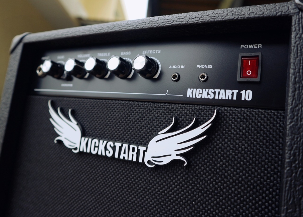 Top section of a large kickstart speaker with the logo "Kickstart" on the front which also includes a set of wings either side of the wording