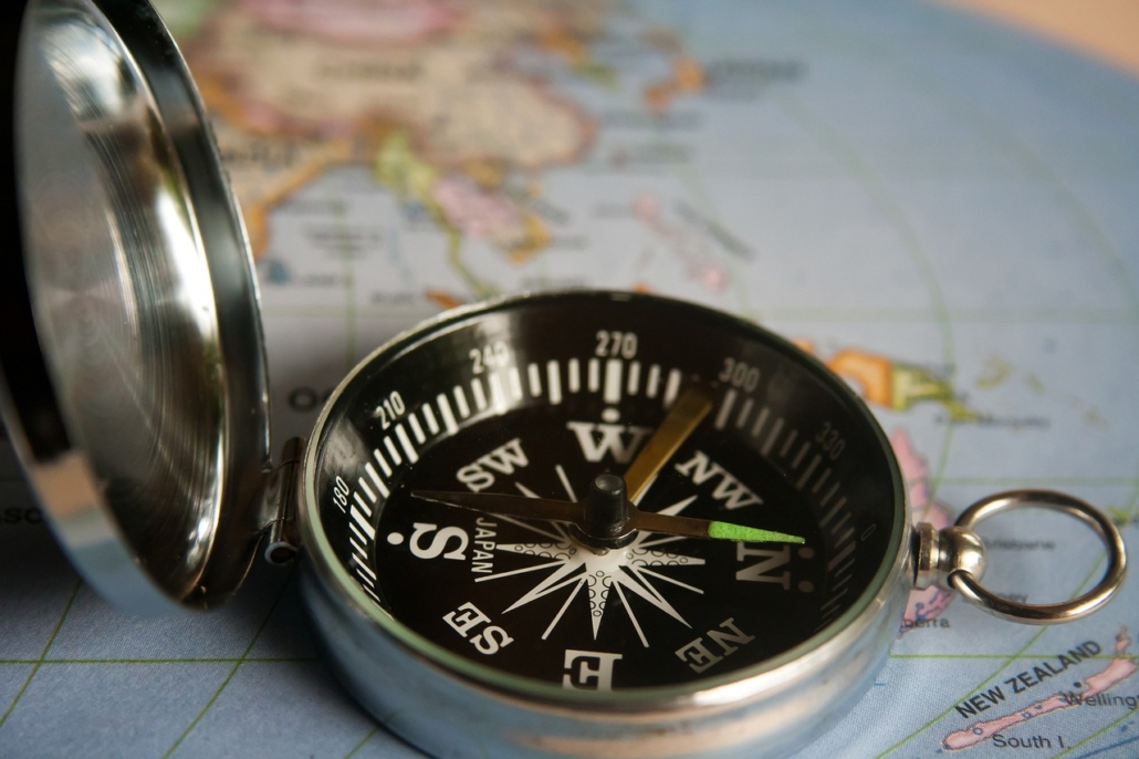 A compass open on a map to depict the idea of guidance