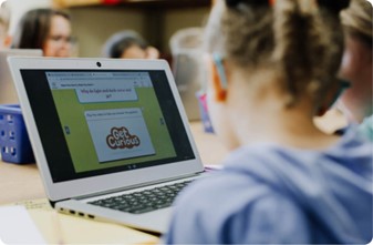 Classroom childre engaging with the HMH product "Get Curious" on a laptop.