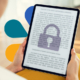 A tablet with blurred content and a superimposed image of a padlock on top indicating lack of access